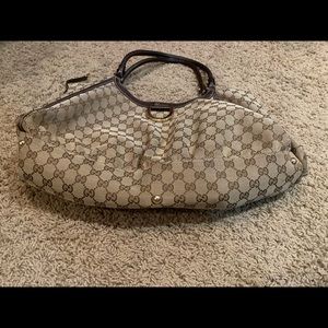 Gucci Bucket Style Purse with G Logo.